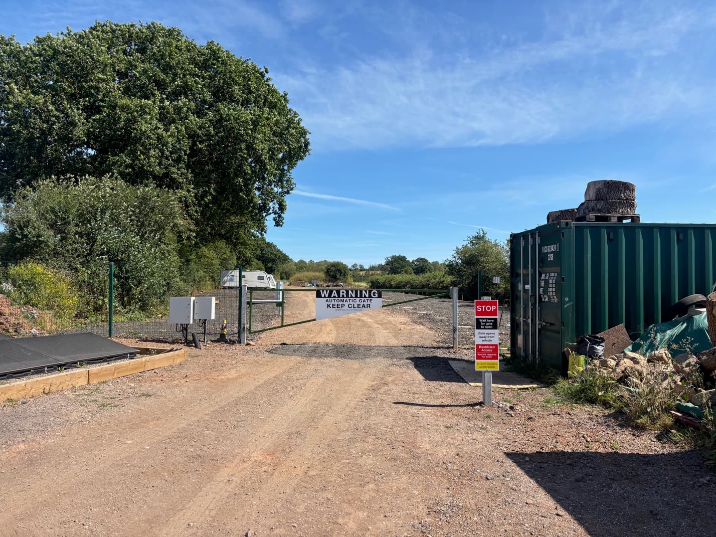 Entrance to the site with automatic gate and warning signage